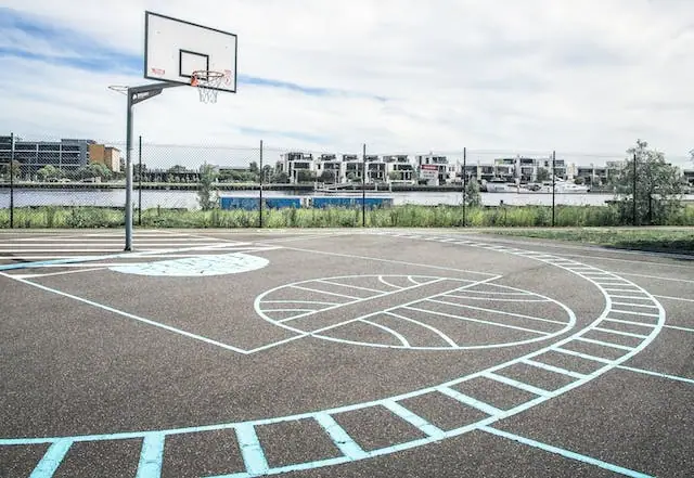 Empty outdoor basketball court with a hoop